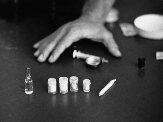 A hand next to a few small vials

Description automatically generated