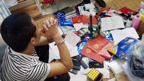 A person sitting on a table with many objects around them
Description automatically generated