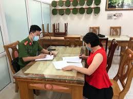 A person and person sitting at a table with papers
Description automatically generated