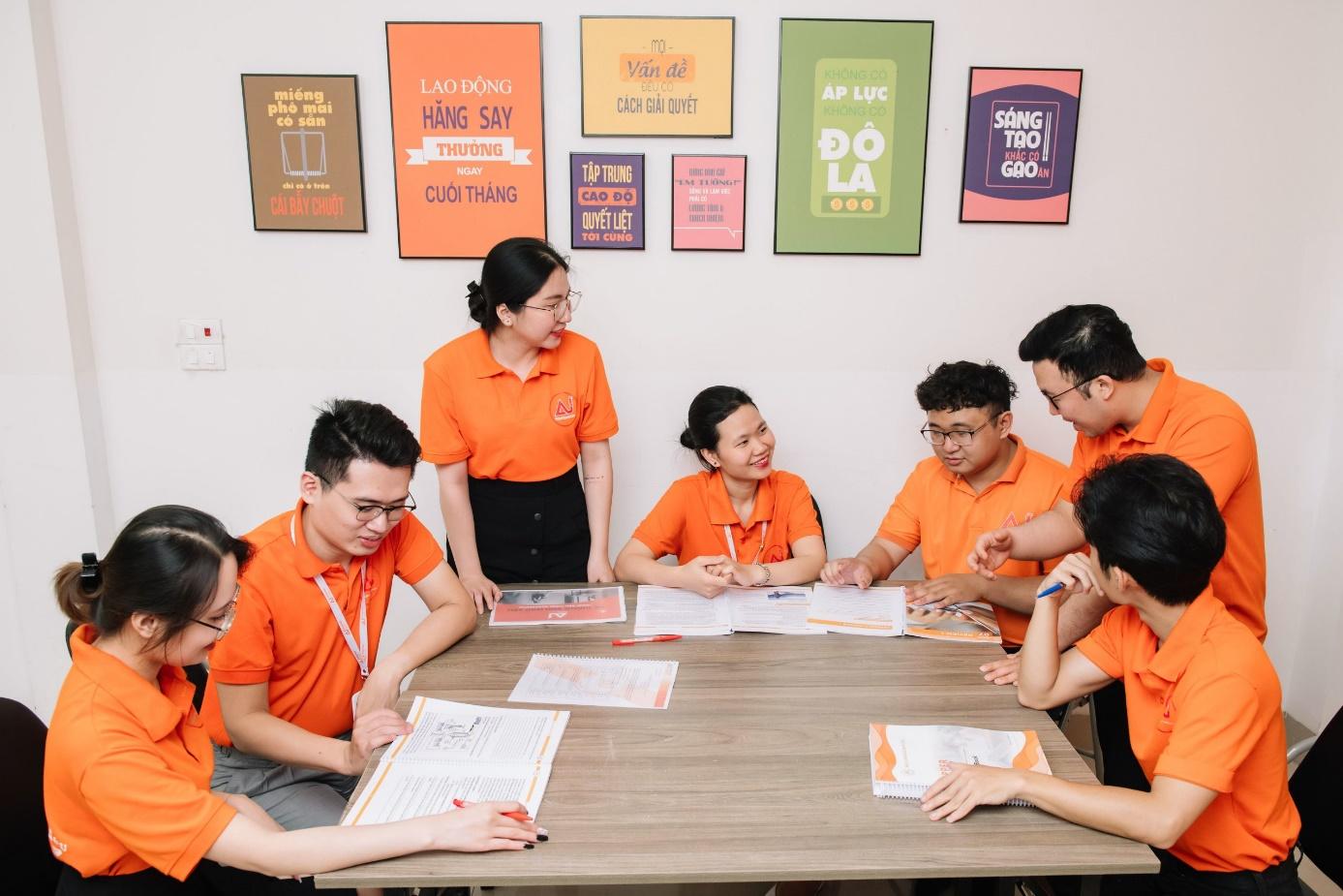 A group of people sitting around a table
Description automatically generated