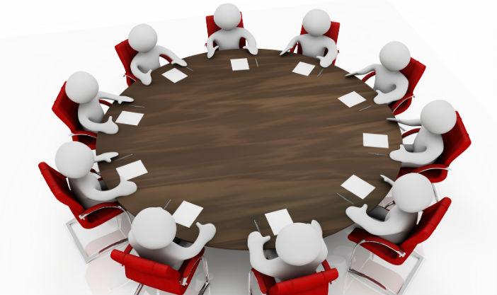 A group of people sitting around a table

AI-generated content may be incorrect.