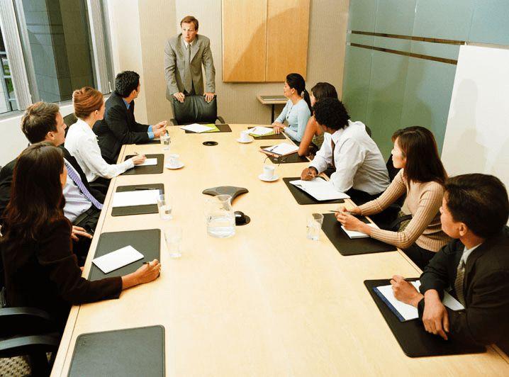 A group of people sitting around a table
AI-generated content may be incorrect.