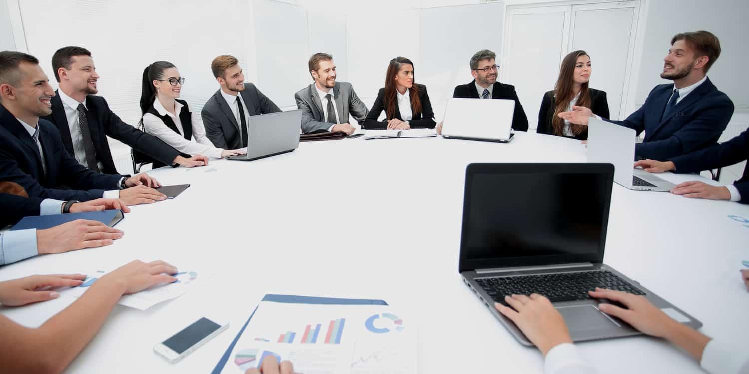 A group of people sitting around a table
AI-generated content may be incorrect.
