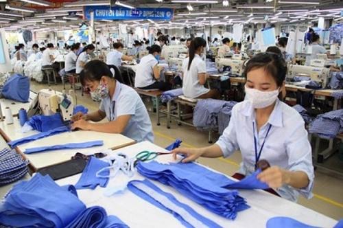 A group of people working in a factory

Description automatically generated