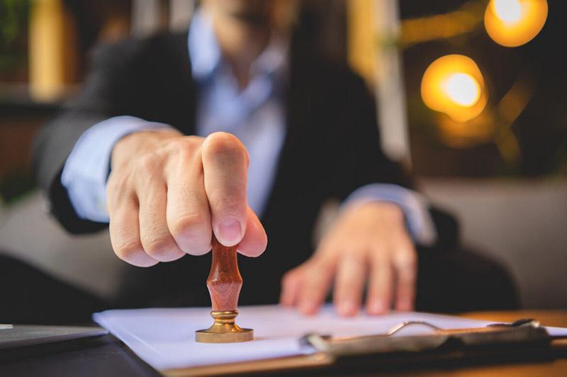 A person holding a stamp
AI-generated content may be incorrect.