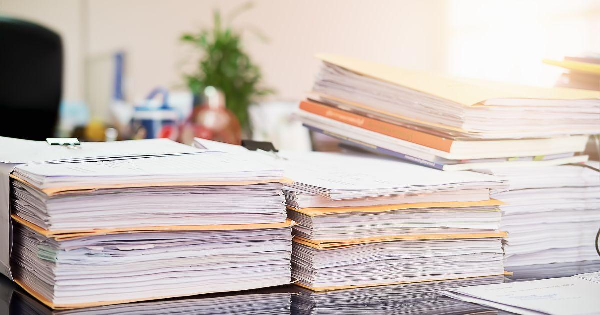 A stack of files on a table

Description automatically generated