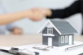 A small model house on a table
Description automatically generated
